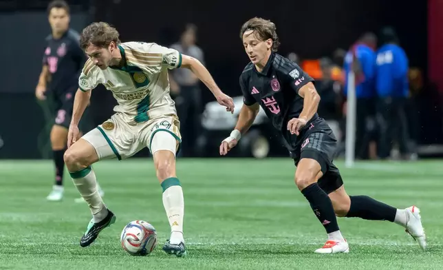 Atlanta United midfielder Alexey Miranchuk, left, and Inter Miami midfielder Matías Galarza, right, battle during the first half of an MLS soccer match Saturday, Oct. 17, 2026, in Atlanta. (AP Photo/Vasha Hunt)