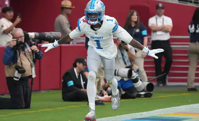 Detroit Lions wide receiver Jameson Williams (1) celebrates his touchdown reception against the Arizona Cardinals during the second half of an NFL football game in Glendale, Ariz., Sunday, Oct. 11, 2026. (AP Photo/Rick Scuteri)