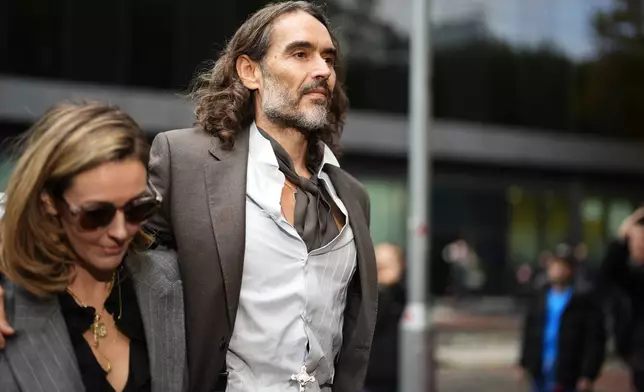 Russell Brand arrives at Southwark Crown Court, London, Tuesday, Oct. 27, 2026, where he faces three charges of rape, indecent assault, and three counts of sexual assault, relating to six women. (Jordan Pettitt/PA via AP)