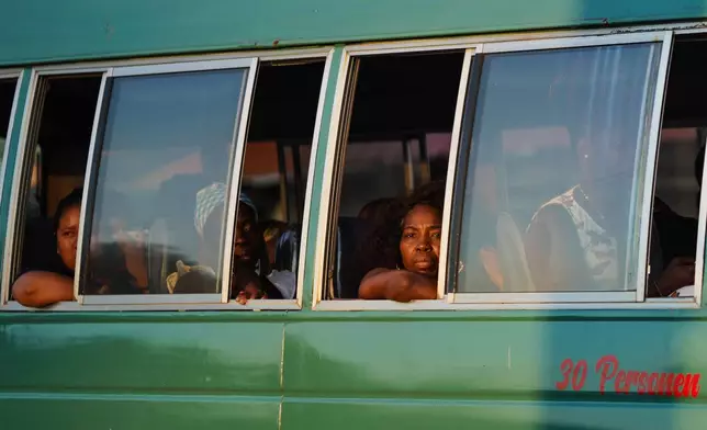People are transported on a local bus in Paramaribo, Suriname, Friday, Sept. 25, 2026. (AP Photo/Ivan Valencia)