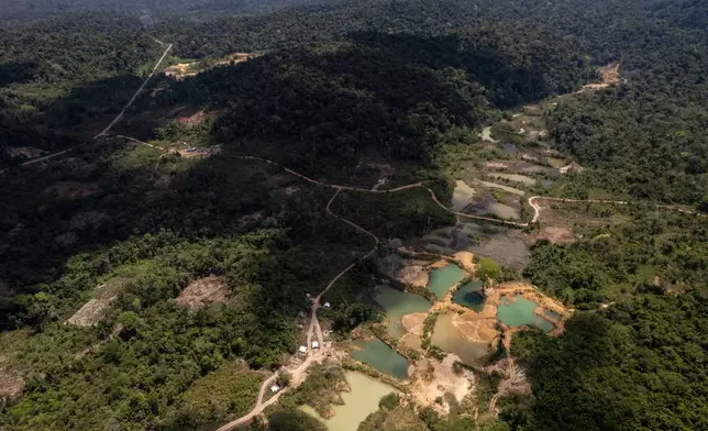 Illegal mining is visible in Saamaka territory of the Amazon rainforest outside Paramaribo, Suriname, Saturday, Sept. 26, 2026. (AP Photo/Ivan Valencia)