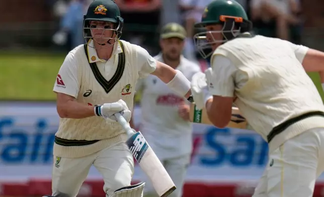 Australia's Steven Smith, left and Australia's Matt Renshaw, right run between the wickets during day four of the second cricket test match between South Africa and Australia, in Gqeberha, South Africa, Wednesday, Oct. 21, 2026. (AP Photo/Themba Hadebe)