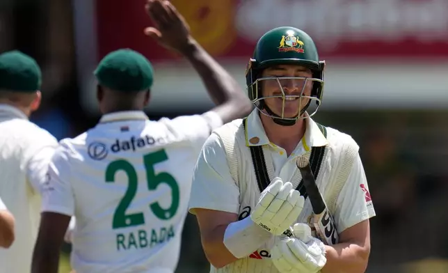 Australia's Matt Renshaw, right, walks back to pavilion after dismissal during day four of the second cricket test match between South Africa and Australia, in Gqeberha, South Africa, Wednesday, Oct. 21, 2026. (AP Photo/Themba Hadebe)