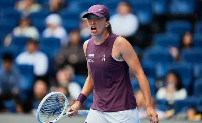Iga Swiatek, of Poland celebrates after winning the match against Iva Jovic, of the United States, during the fourth round of the women's singles match at the China Open tennis tournament in Beijing, Wednesday, Oct. 7, 2026. (AP Photo/Andy Wong)