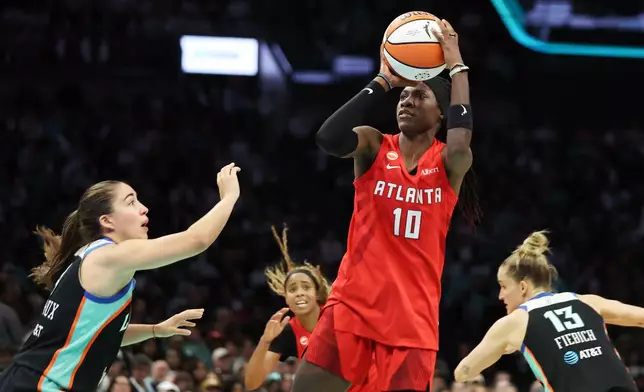 Atlanta Dream guard Rhyne Howard (10) looks to shoot over New York Liberty guard Marine Fauthoux, left, during the second half of Game 3 of the WNBA basketball semifinals, Friday, Oct. 9, 2026, in New York. (AP Photo/Heather Khalifa)