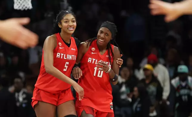 Atlanta Dream forward Angel Reese (5) and Atlanta Dream guard Rhyne Howard (10) react after their team defeated the New York Liberty in Game 3 of the WNBA basketball semifinals, Friday, Oct. 9, 2026, in New York. (AP Photo/Heather Khalifa)