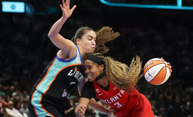 Atlanta Dream guard Jordin Canada (3) is defended by New York Liberty guard Marine Fauthoux, left, during the second half of Game 3 of the WNBA basketball semifinals, Friday, Oct. 9, 2026, in New York. (AP Photo/Heather Khalifa)