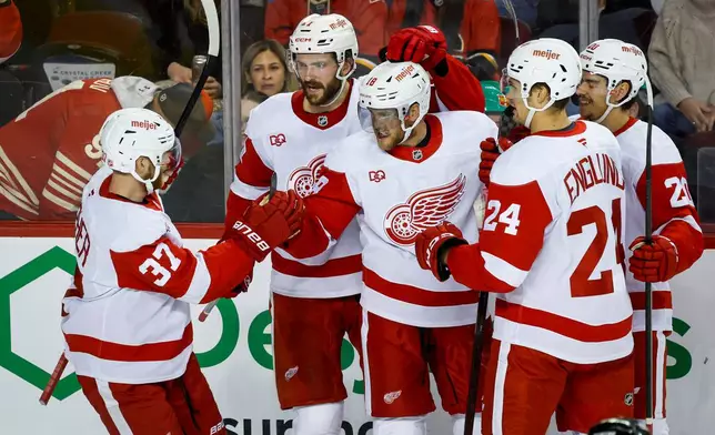 Detroit Red Wings' Andrew Copp, center, celebrates his goal with teammates during second period NHL hockey action against the Calgary Flames in Calgary, Alberta, Saturday, Oct. 24, 2026. (Jeff McIntosh/The Canadian Press via AP)