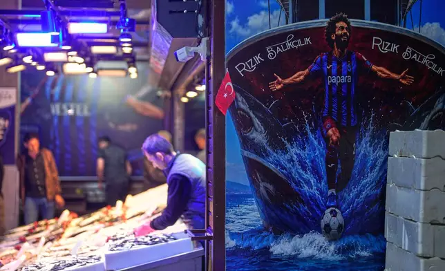 A mural depicting Trabzonspor's Egyptian soccer player Mohamed Salah is displayed on the wall of a seafood shop in Trabzon, Turkey, Tuesday, Oct. 20, 2026. (AP Photo/Khalil Hamra)