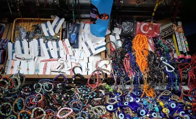 A scarf featuring Trabzonspor's Egyptian soccer player Mohamed Salah is displayed among souvenirs for sale at a street stall in Trabzon, Turkey, Monday, Oct. 19, 2026. (AP Photo/Khalil Hamra)