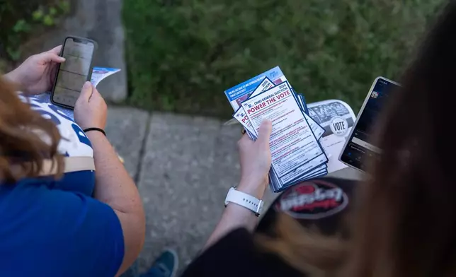 Morgan Hughes, left, and Jordan "JoJo" Burkhard, right, both members of UAW Local 402, in Springfield, Ohio, canvas for votes in Kettering, Ohio, Monday, Sept. 28, 2026. (AP Photo/Carolyn Kaster)