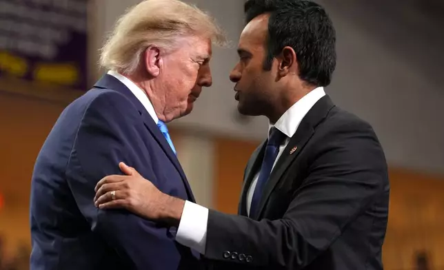 Ohio Republican gubernatorial candidate Vivek Ramaswamy, right, shakes the hand of President Donald Trump after speaking during an event at Butler High School in Vandalia, Ohio, Saturday, Oct. 3, 2026. (AP Photo/Mark Schiefelbein)