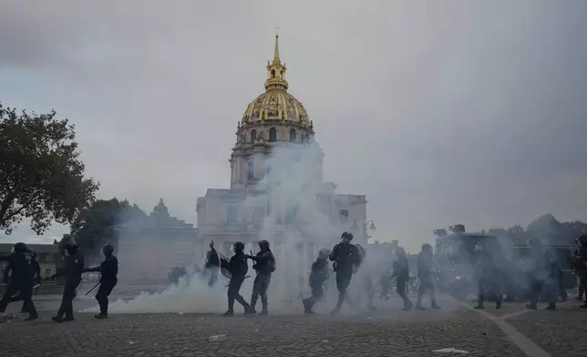 Police faces students after a march to protest against under-resourced schools in Paris, Tuesday Oct. 13, 2026. (AP Photo/Thibault Camus)