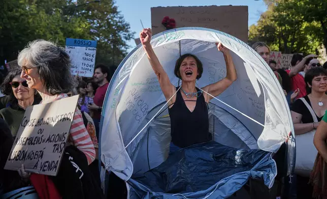 People march during a protest to demand affordable housing in Lisbon, Portugal, Saturday, Oct. 24, 2026. (AP Photo/Ana Brigida)