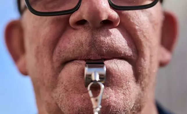 A man whistles during a pensioners' march to defend retirement rights in Madrid, Spain, on Saturday, Oct. 24, 2026. (AP Photo/Bernat Armangue)