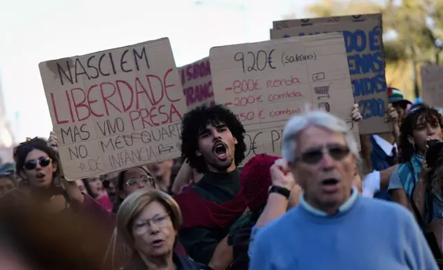 People march during a protest to demand affordable housing in Lisbon, Saturday, Oct. 24, 2026. (AP Photo/Ana Brigida)