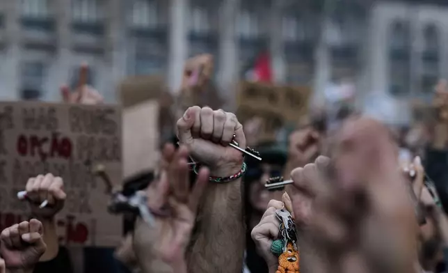 People hold keys during a protest to demand affordable housing in Lisbon, Saturday, Oct. 24, 2026. (AP Photo/Ana Brigida)