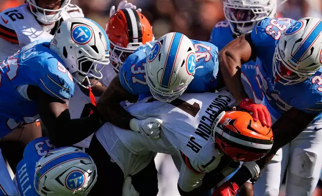 Cleveland Browns wide receiver KC Concepcion (1) is brought down by Tennessee Titans linebacker Anthony Hill Jr. (53), defensive end Truman Jones (56), safety Amani Hooker (37), and linebacker Cedric Gray (33) during the first half of an NFL football game in Nashville, Tenn., Sunday, Oct. 25, 2026. (AP Photo/George Walker IV)