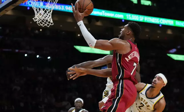 Miami Heat forward Giannis Antetokounmpo (7) goes to the basket as Indiana Pacers guard Andrew Nembhard (2) defends during the first half of an NBA Cup basketball game, Friday, Oct. 30, 2026, in Miami. (AP Photo/Lynne Sladky)