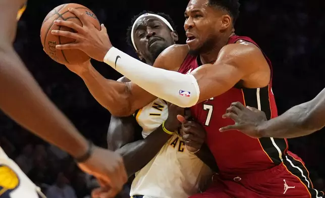 Miami Heat forward Giannis Antetokounmpo, right, drives to the basket as Indiana Pacers forward Pascal Siakam, left, defends during the first half of an NBA Cup basketball game, Friday, Oct. 30, 2026, in Miami. (AP Photo/Lynne Sladky)