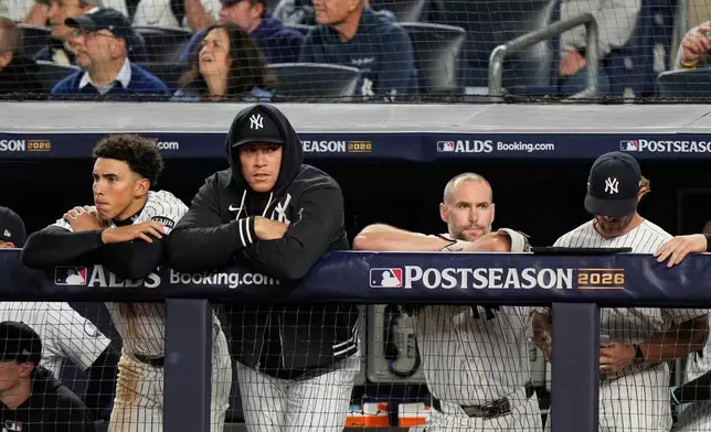 New York Yankees players watch play against the Tampa Bay Rays during the seventh inning in Game 3 of baseball's American League Division Series, Wednesday, Oct. 7, 2026, in New York. (AP Photo/Seth Wenig)
