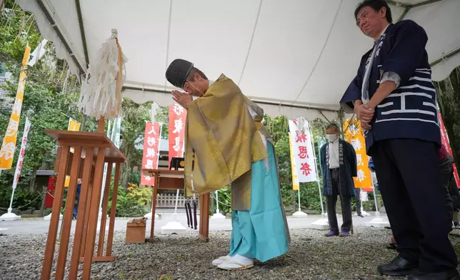 A Shinto priest performs rituals during a doll memorial ceremony at Dairokuten Sakaki Shrine in Tokyo, Tuesday, Oct. 13, 2026. (AP Photo/Eugene Hoshiko)