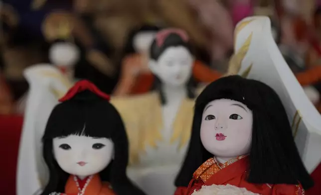 Dolls no longer used by their owners are seen during a doll memorial ceremony at Dairokuten Sakaki Shrine in Tokyo, Tuesday, Oct. 13, 2026. (AP Photo/Eugene Hoshiko)