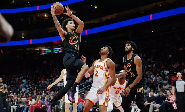 Cleveland Cavaliers guard Tyrese Proctor (24) drives against Atlanta Hawks guard Aaron Wiggins (2) during the first half of an NBA basketball game, Thursday, Oct. 29, 2026, in Atlanta. (AP Photo/Erik S. Lesser)
