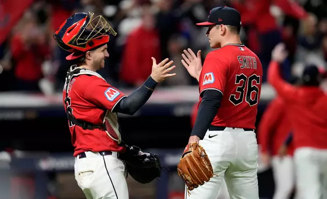 Cleveland Guardians catcher Patrick Bailey, left, celebrates with pitcher Cade Smith (36) after Game 5 of baseball's American League Division Series against the Chicago White Sox, Saturday, Oct. 10, 2026, in Cleveland. (AP Photo/Sue Ogrocki)