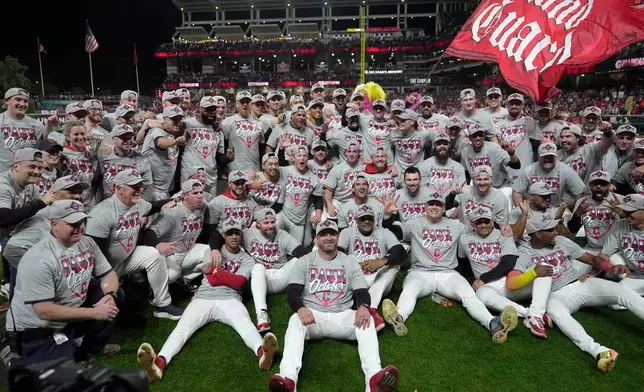 Cleveland Guardians players and coaches celebrate after Game 5 of baseball's American League Division Series against the Chicago White Sox, Saturday, Oct. 10, 2026, in Cleveland. (AP Photo/Sue Ogrocki)