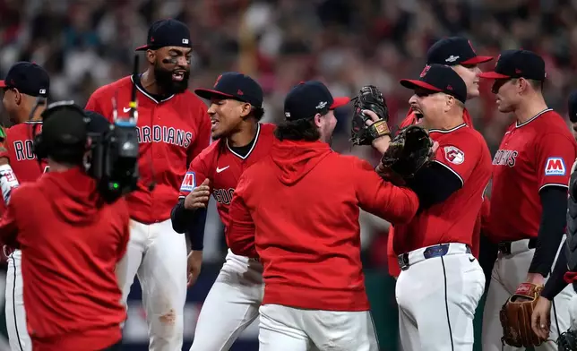 Cleveland Guardians players celebrate after Game 5 of baseball's American League Division Series against the Chicago White Sox, Saturday, Oct. 10, 2026, in Cleveland. (AP Photo/Sue Ogrocki)
