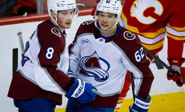 Colorado Avalanche's Cale Makar (8) celebrates after his goal with teammate Artturi Lehkonen (62) during the second period of an NHL hockey game against the Calgary Flames in Calgary, Alberta, Thursday, Oct. 8, 2026. (Jeff McIntosh/The Canadian Press via AP)