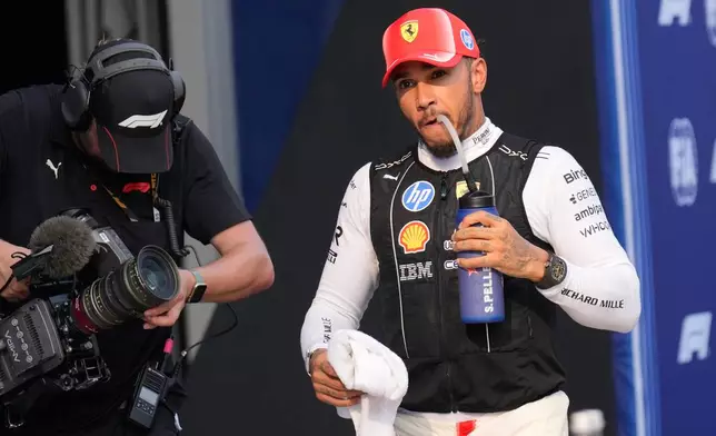 Ferrari driver Lewis Hamilton of Britain drinks after the qualifying session ahead of the Bahrain Grand Prix in Sepang, Malaysia, Saturday, Oct. 3, 2026. (AP Photo/Aijaz Rahi)