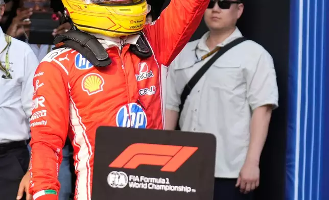 Second fastest time Ferrari driver Lewis Hamilton of Britain waves to spectators after the qualifying session ahead of the Bahrain Grand Prix in Sepang, Malaysia, Saturday, Oct. 3, 2026. (AP Photo/Aijaz Rahi)