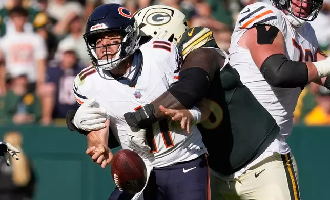 Chicago Bears' Case Keenum fumbles as he is hit by Green Bay Packers' Devonte Wyatt during the second half of an NFL football game in Green Bay, Wis., Sunday, Oct. 11, 2026. (AP Photo/Nam Huh)