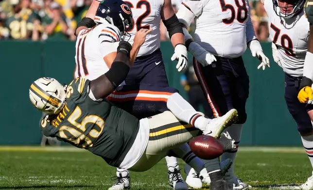 Chicago Bears' Case Keenum fumbles as he is hit by Green Bay Packers' Devonte Wyatt during the second half of an NFL football game in Green Bay, Wis., Sunday, Oct. 11, 2026. (AP Photo/Nam Huh)