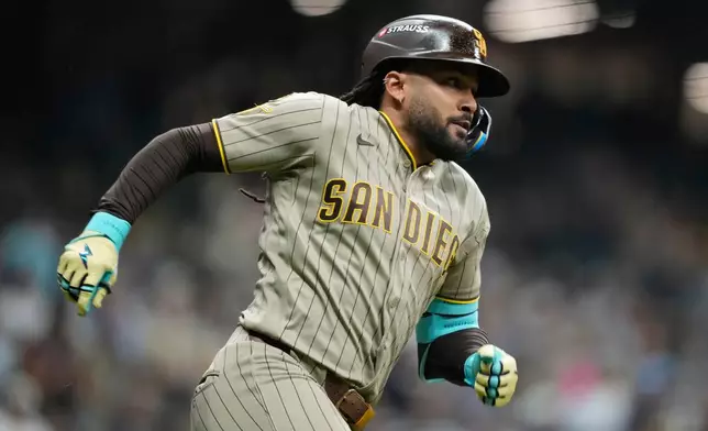 San Diego Padres' Fernando Tatis Jr. hits a single during the seventh inning in Game 1 of a National League Divisional baseball playoff series against the Milwaukee Brewers Saturday, Oct. 3, 2026, in Milwaukee. (AP Photo/Kayla Wolf)