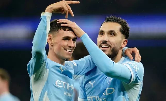 Manchester City's Phil Foden, left, and Manchester City's Rayan Cherki celebrate the thrid goal during the Champions League soccer match between Manchester City and AEK Athens in Manchester, England, Tuesday, Oct. 20, 2026. (AP Photo/Dave Thompson)