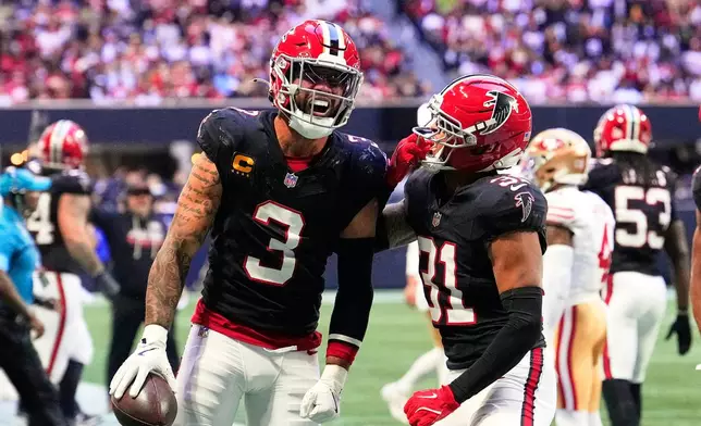 Atlanta Falcons safety Jessie Bates III (3) and Xavier Watts (31) celebrate after Bates III intercepted a San Francisco 49ers' Brock Purdy pass during the second half of an NFL football game in Atlanta, Sunday, Oct. 25, 2026. (AP Photo/Brynn Anderson)