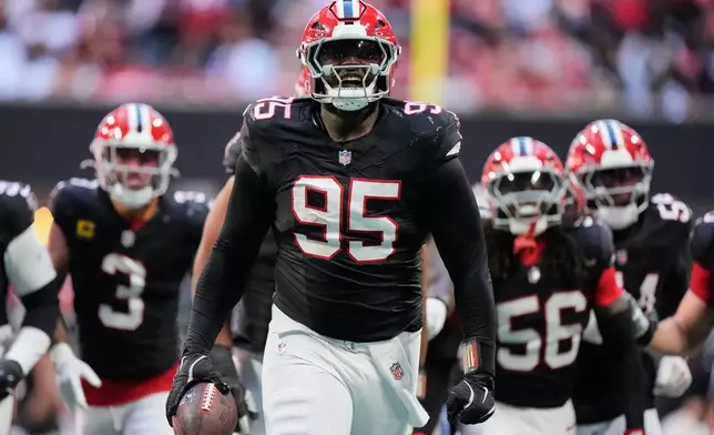 Atlanta Falcons defensive tackle Gervon Dexter Sr. (95) celebrates with teammates after recovering a San Francisco 49ers fumble during the first half of an NFL football game in Atlanta, Sunday, Oct. 25, 2026. (AP Photo/Mike Stewart)