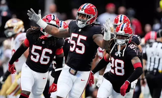 Atlanta Falcons' Za'darius Smith (55), Harold Perkins Jr. (56) and Mike Ford Jr. (28) celebrate after sacking San Francisco 49ers quarterback Brock Purdy during the second half of an NFL football game in Atlanta, Sunday, Oct. 25, 2026. (AP Photo/Mike Stewart)
