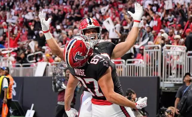 Atlanta Falcons tight end Nick Muse (87) and Charlie Woerner celebrate after Muse caught a touchdown pass during the first half of an NFL football game against the San Francisco 49ers in Atlanta, Sunday, Oct. 25, 2026. (AP Photo/Mike Stewart)