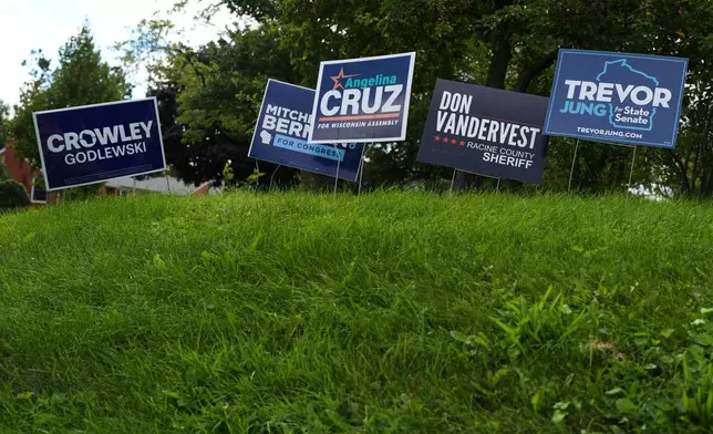 Signs for Democratic candidates in the 2026 midterm election are seen outside of a home in Racine, Wis., Tuesday, Sept. 22, 2026. (AP Photo/Nam Y. Huh)
