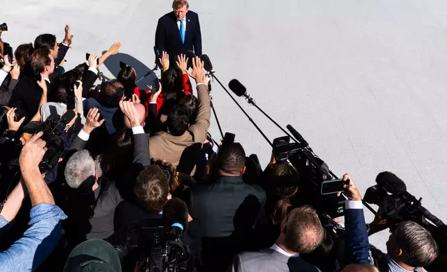 President Donald Trump talks with reporters before boarding Marine One on the South Lawn of the White House, Monday, Oct. 5, 2026, in Washington. (AP Photo/Julia Demaree Nikhinson)