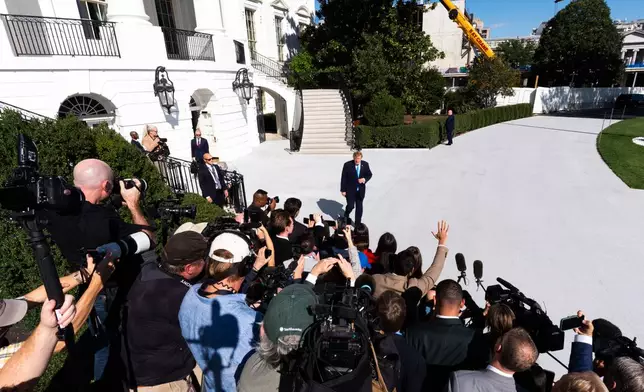 President Donald Trump talks with reporters before boarding Marine One on the South Lawn of the White House, Monday, Oct. 5, 2026, in Washington. (AP Photo/Julia Demaree Nikhinson)