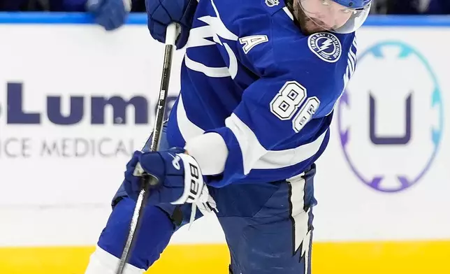 Tampa Bay Lightning right wing Nikita Kucherov (86) takes a shot against the Vancouver Canucks during the second period of an NHL hockey game Saturday, Oct. 17, 2026, in Tampa, Fla. (AP Photo/Chris O'Meara)