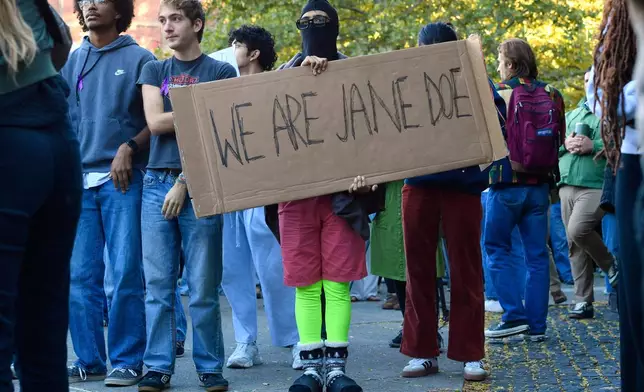 A demonstrator holds a sign reading "WE ARE JANE DOE" during a protest against Cornell University's handling of the 2024 fraternity-house gang rape allegations at the campus, Monday, Oct. 5, 2026, in Ithaca, N.Y. (AP Photo/Adrian Kraus)