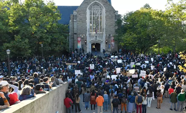 Demonstrators listen to a speaker during a protest against Cornell University's handling of the 2024 fraternity-house gang rape allegations at the campus, Monday, Oct. 5, 2026, in Ithaca, N.Y. (AP Photo/Adrian Kraus)