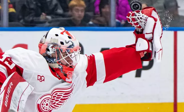 Detroit Red Wings goaltender Michal Postava (35) stops the puck against the Vancouver Canucks during the third period of an NHL hockey game in Vancouver, British Columbia, Thursday, Oct. 22, 2026. (Ethan Cairns/The Canadian Press via AP)