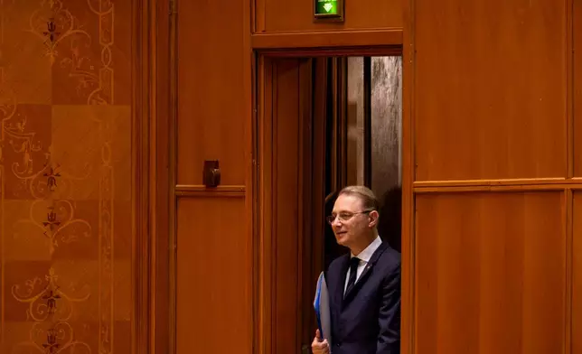 Romanian Prime Minister designate Luca Niculescu arrives for a joint parliament session called to give a vote of confidence for the new government team, in Bucharest, Romania, Tuesday, Oct. 20, 2026. (AP Photo/Andreea Alexandru)
